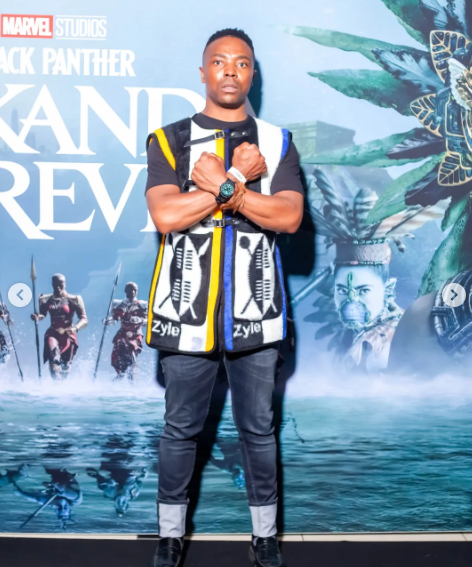 A guest wearing the Zyle Idzila Vest at the Wakanda Forever premiere, front view, 2022.