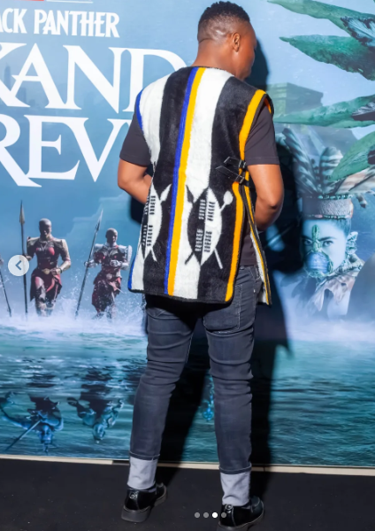 The same guest from behind, showing the Idzila Vest's geometric stripe pattern at the Wakanda Forever premiere, 2022.